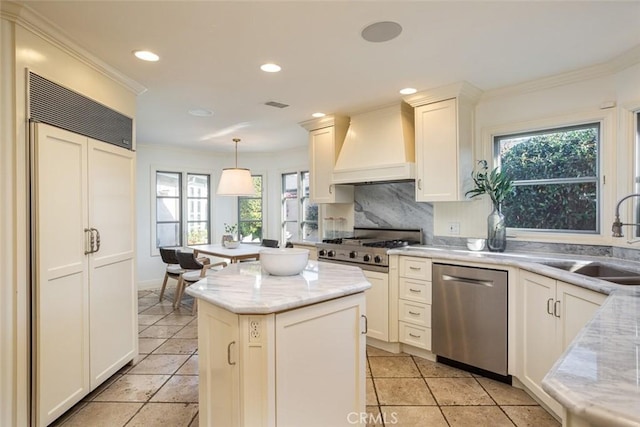 kitchen featuring custom exhaust hood, sink, pendant lighting, dishwasher, and plenty of natural light