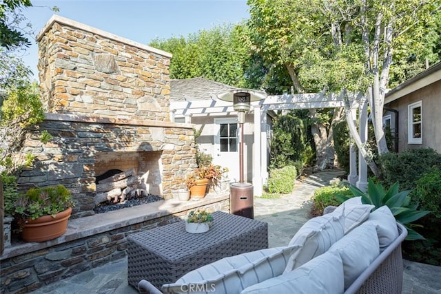 view of patio featuring an outdoor living space with a fireplace