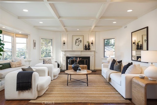 living room with hardwood / wood-style floors, crown molding, coffered ceiling, and beam ceiling