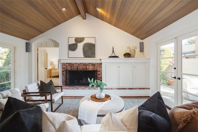 living room with french doors, a healthy amount of sunlight, and hardwood / wood-style floors