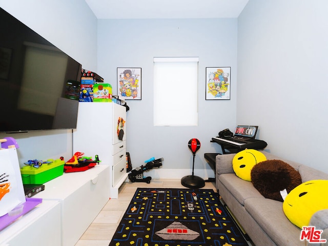 game room with light wood-type flooring