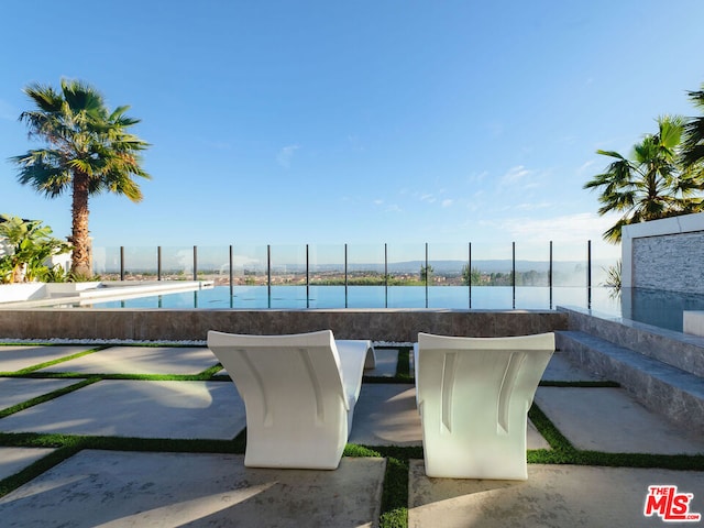 view of swimming pool featuring a water view