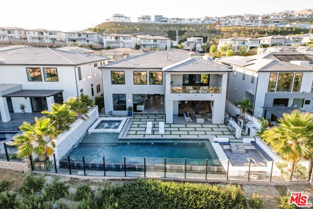 back of house with a pool with hot tub and a patio area