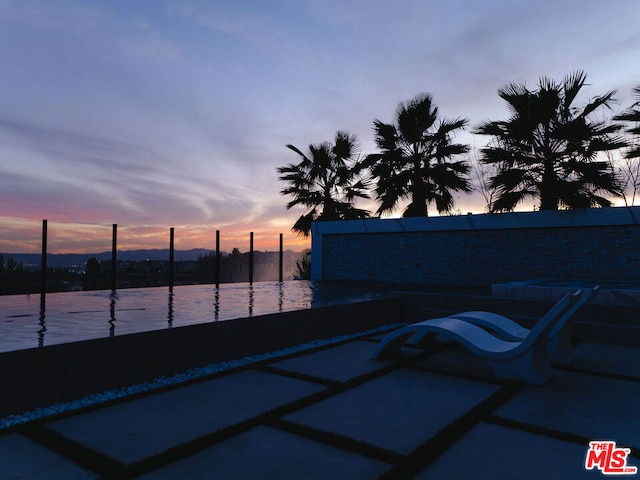 patio terrace at dusk with a water view