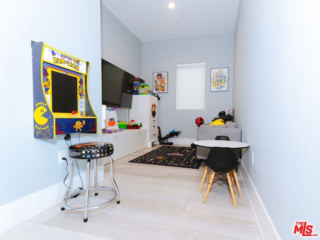 game room with light hardwood / wood-style floors