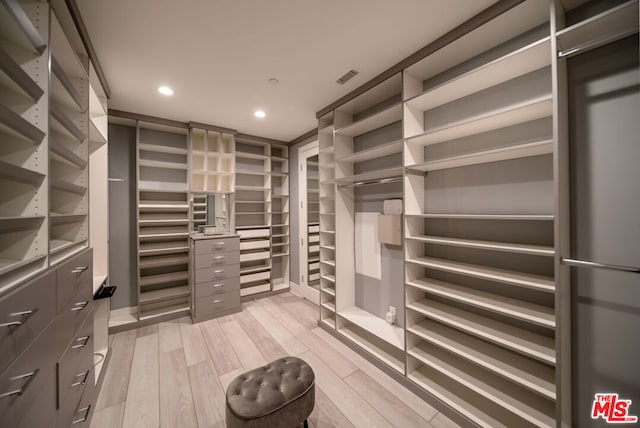 walk in closet with light wood-type flooring