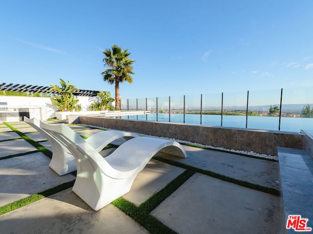 view of swimming pool with a water view