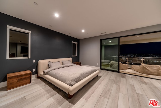 bedroom featuring light hardwood / wood-style floors and access to outside