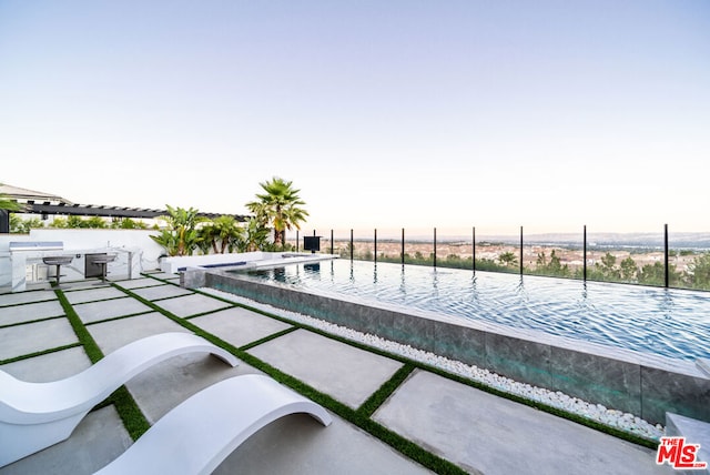 view of pool with a patio and area for grilling