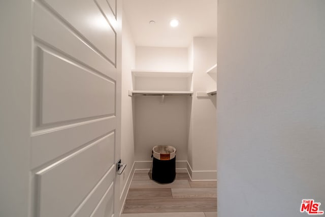 walk in closet featuring light hardwood / wood-style flooring