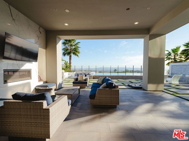 view of patio / terrace featuring an outdoor living space and a water view