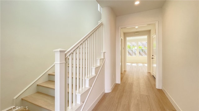 stairway with hardwood / wood-style floors