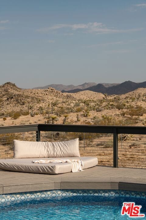 view of pool with a deck with mountain view