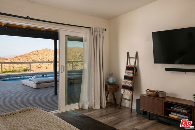 doorway to outside with a mountain view and dark hardwood / wood-style flooring