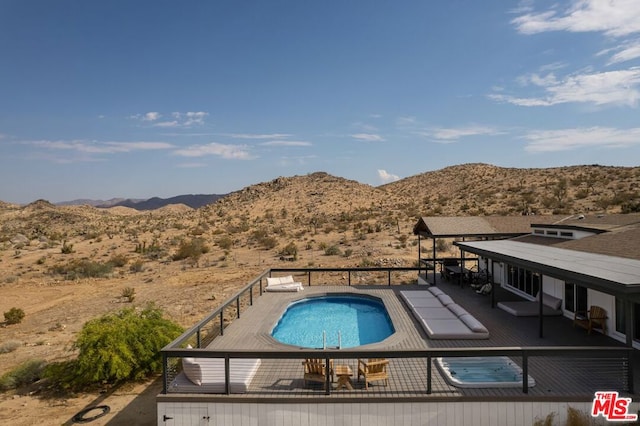 view of pool with a mountain view and a patio area