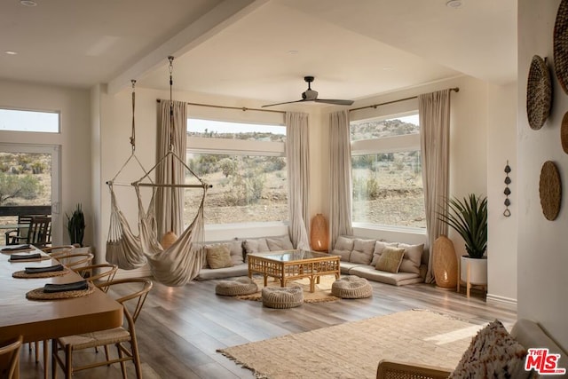 sitting room with wood-type flooring and ceiling fan