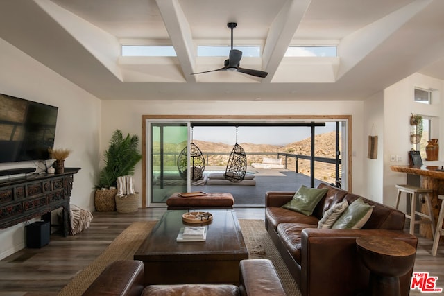 living room featuring dark hardwood / wood-style flooring, a mountain view, ceiling fan, and a wealth of natural light