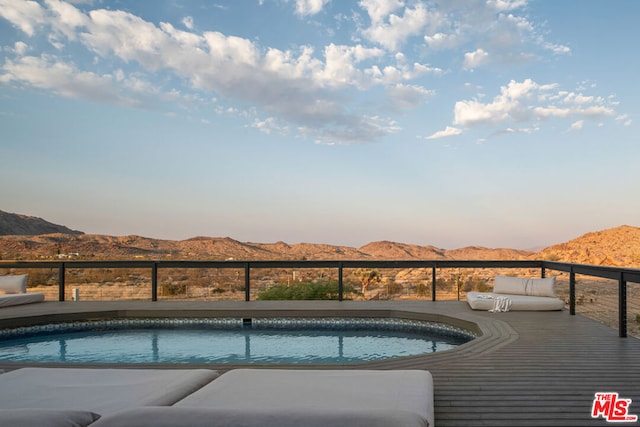 view of swimming pool with a mountain view