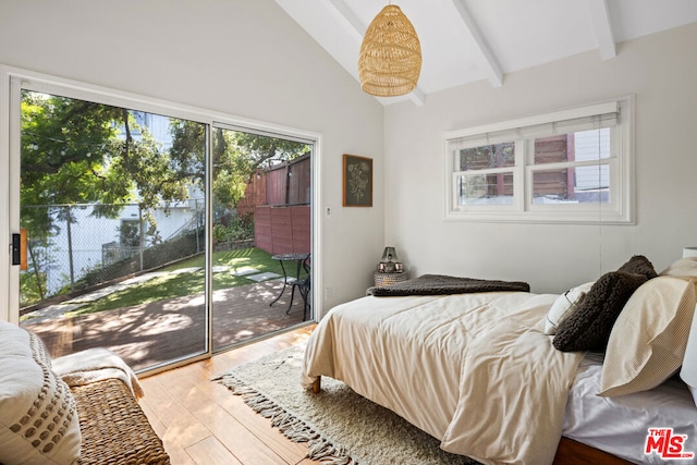 bedroom with lofted ceiling with beams, hardwood / wood-style flooring, and access to outside