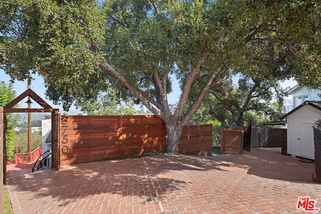 view of patio featuring a storage unit