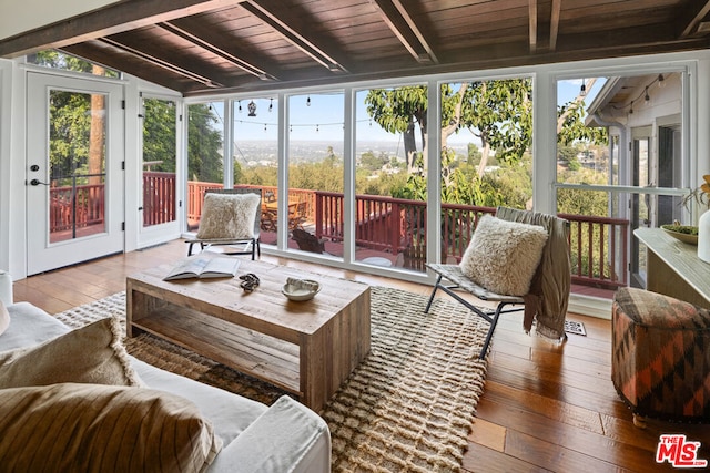 sunroom / solarium featuring wood ceiling and lofted ceiling with beams