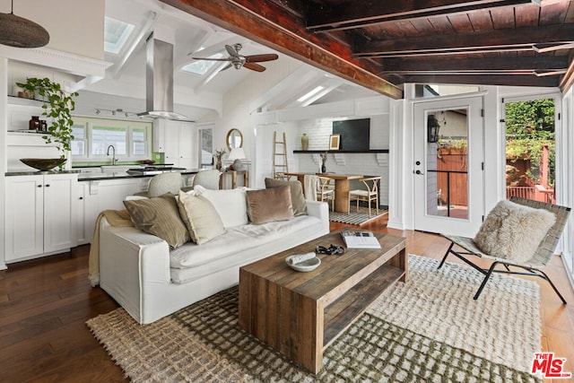 living room featuring sink, ceiling fan, vaulted ceiling with beams, dark hardwood / wood-style flooring, and wooden ceiling