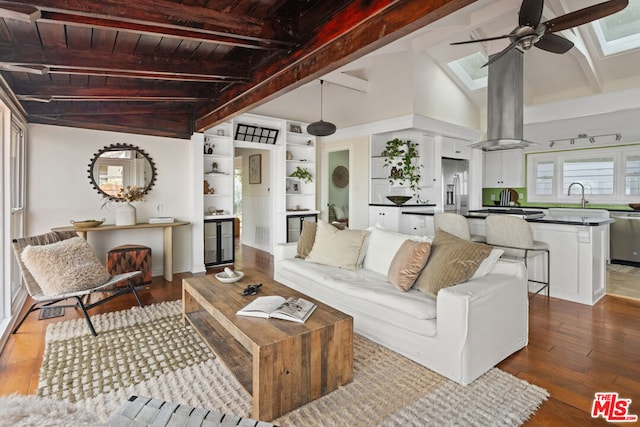 living room with lofted ceiling with skylight, hardwood / wood-style floors, sink, ceiling fan, and wooden ceiling