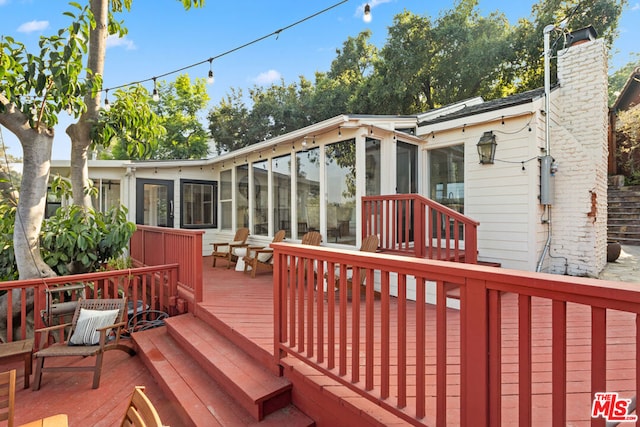 wooden terrace with a sunroom