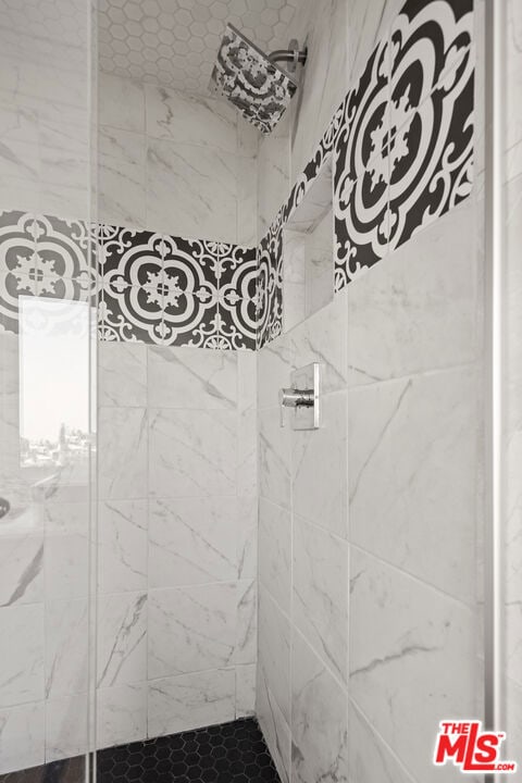 bathroom with tiled shower