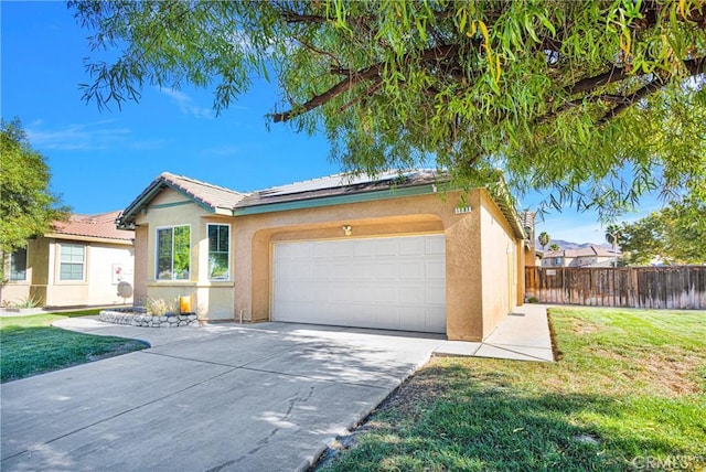 single story home featuring solar panels, a garage, and a front lawn