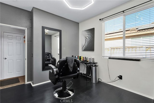 exercise room with a wealth of natural light and dark hardwood / wood-style floors