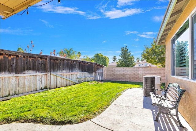 view of yard featuring central air condition unit and a patio