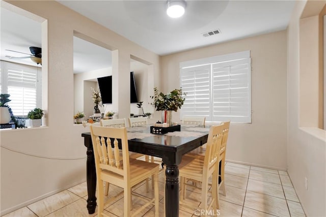 tiled dining room featuring ceiling fan