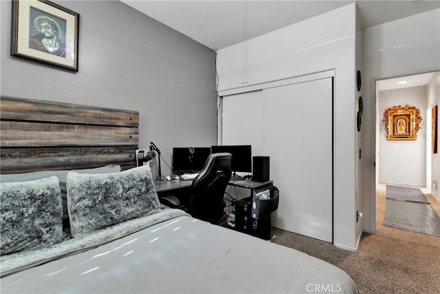 carpeted bedroom featuring a closet