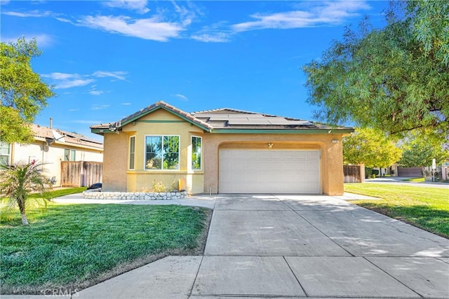 view of front of house featuring a front yard, solar panels, and a garage