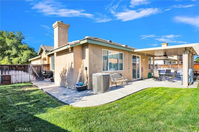 back of house with a lawn, ceiling fan, central AC unit, and a patio area