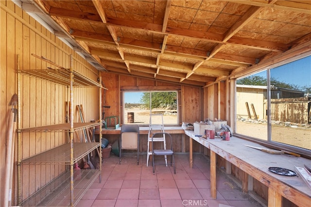 interior space featuring wood walls, wooden ceiling, and lofted ceiling