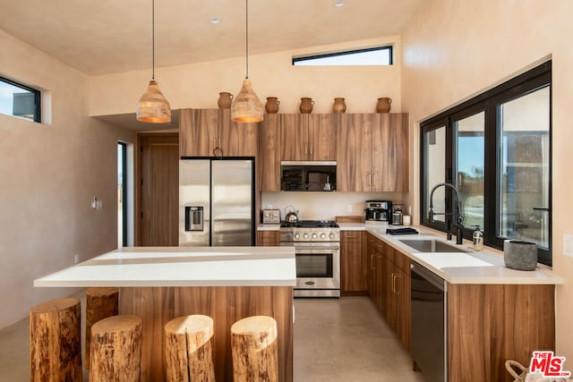 kitchen featuring lofted ceiling, sink, appliances with stainless steel finishes, and a healthy amount of sunlight