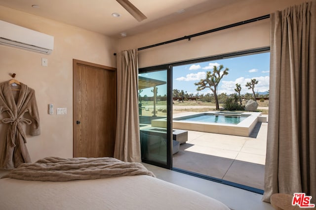 bedroom with a wall unit AC, access to exterior, and ceiling fan