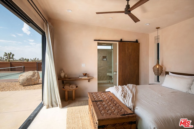 bedroom featuring a barn door, ensuite bathroom, access to exterior, and ceiling fan