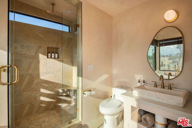 bathroom with toilet and a shower with shower door