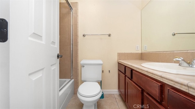 full bathroom featuring vanity, toilet, tile patterned flooring, and bath / shower combo with glass door