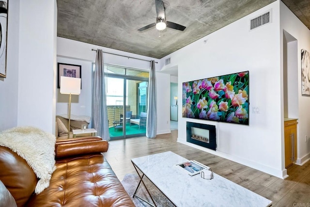 living room featuring light wood-type flooring and ceiling fan