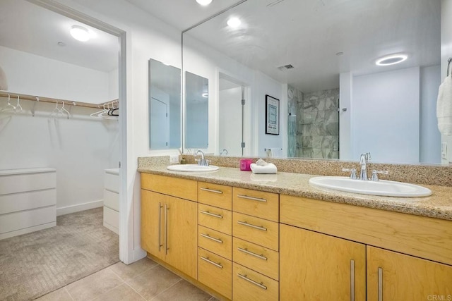 bathroom with vanity, tile patterned flooring, and an enclosed shower