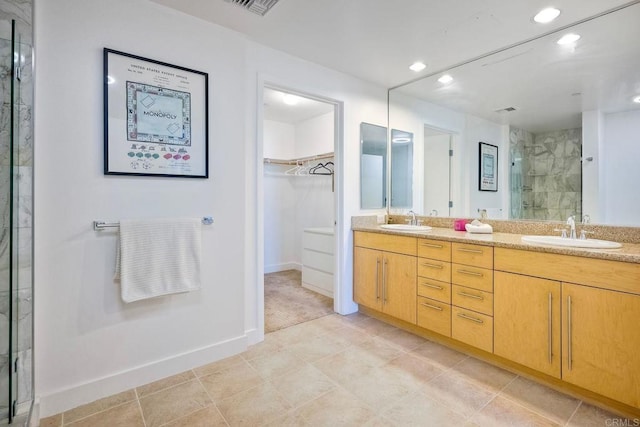 bathroom with vanity, tile patterned flooring, and a shower with door