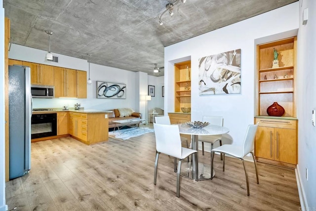 dining room featuring ceiling fan and light wood-type flooring