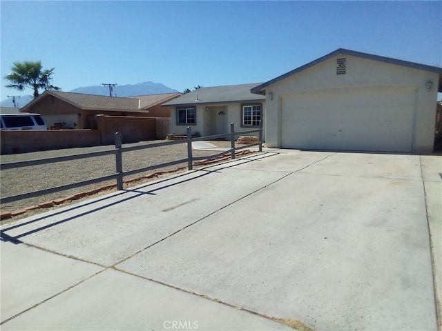 single story home featuring a mountain view and a garage