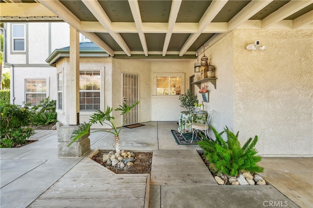 view of exterior entry featuring a patio area