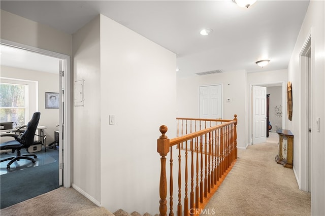 corridor with light colored carpet