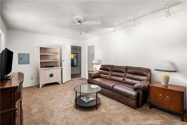 living room featuring light carpet, a textured ceiling, rail lighting, and ceiling fan